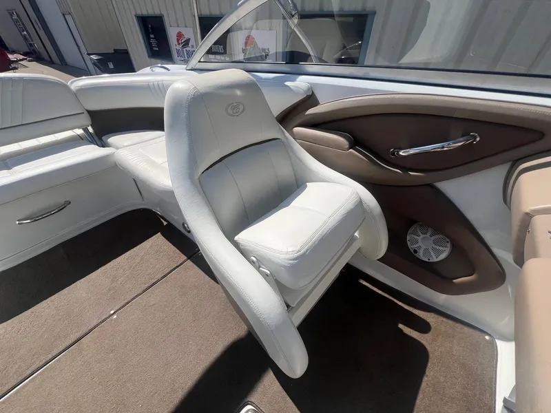 Slide: The Image of Interior of a 2007 Cobalt 232 boat with white seating and brown accents. - 19