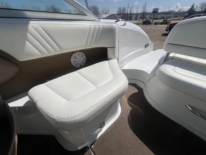 Slide: The Image of 2007 Cobalt 232 boat interior with white leather seating and speaker. - 23