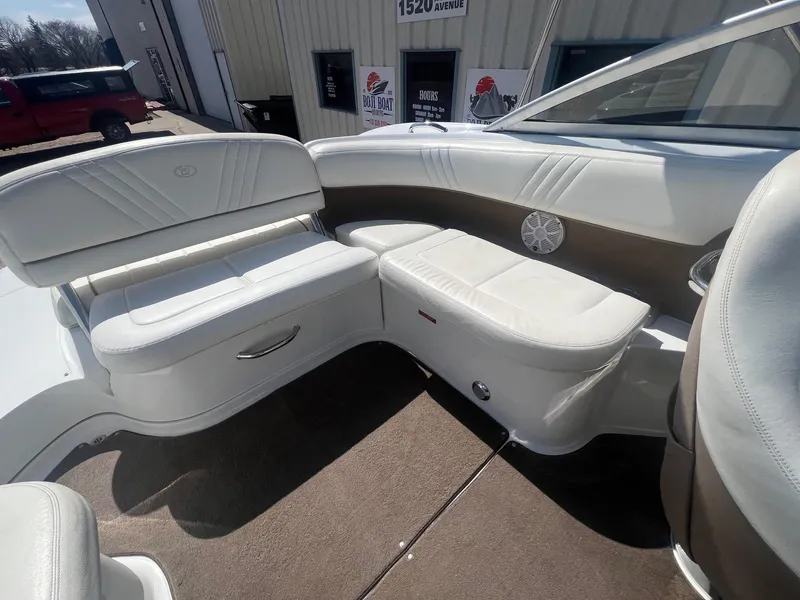 Slide: The Image of Interior of a 2007 Cobalt 232 boat with white leather seating and carpeted floor. - 24
