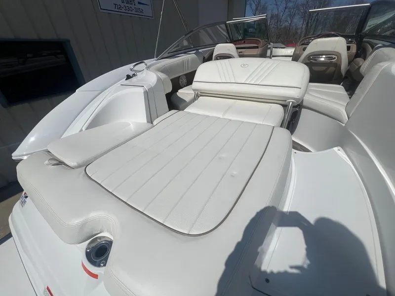 Slide: The Image of 2007 Cobalt 232 boat interior with white leather seating and open cockpit. - 26