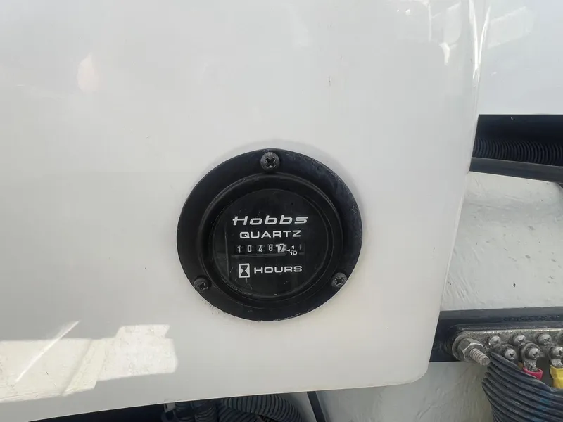 Slide: The Image of Hobbs Quartz hour meter on 2007 Cobalt 232 boat, displaying 1048.1 hours. - 32