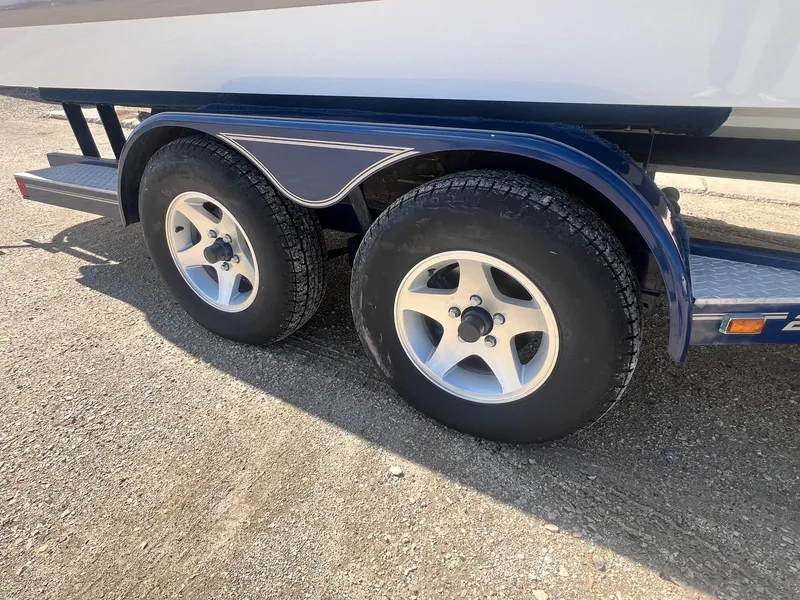Slide: The Image of Trailer wheels of a 2007 Cobalt 232 boat on a sunny day. - 34
