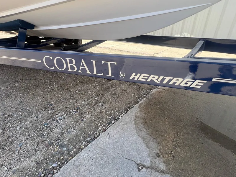 Slide: The Image of Trailer for 2007 Cobalt 232 boat by Heritage, parked on gravel. - 36