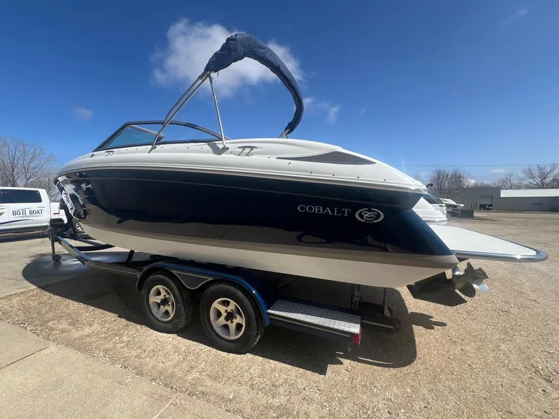 Slide: The Image of 2007 Cobalt 232 boat on trailer under clear blue sky. - 4