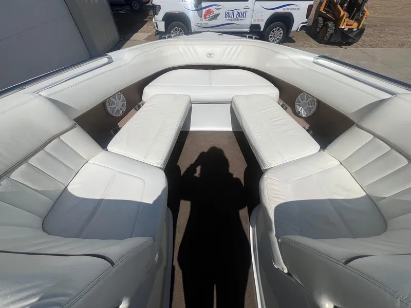 Slide: The Image of 2007 Cobalt 232 boat interior with white leather seating and visible shadow. - 9