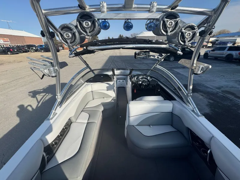 Slide: The Image of 2007 Supra 22SSV boat interior with speakers and seating, parked outdoors. - 12
