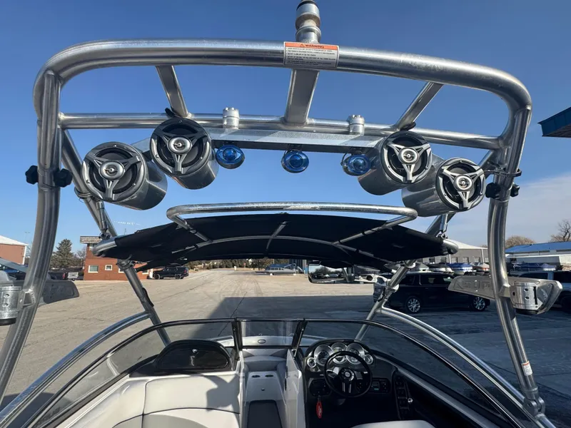 Slide: The Image of 2007 Supra 22SSV boat interior with speakers and steering wheel, parked outdoors. - 13