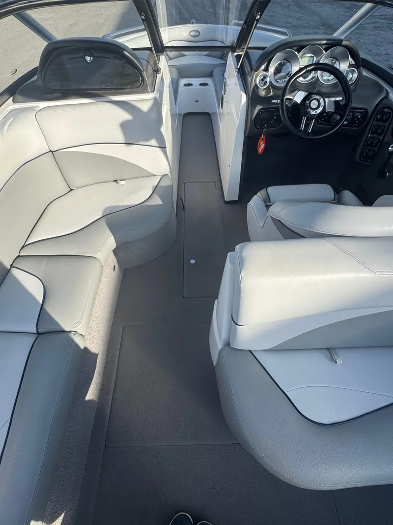 Slide: The Image of 2007 Supra 22SSV boat interior with white seating and modern dashboard. - 14