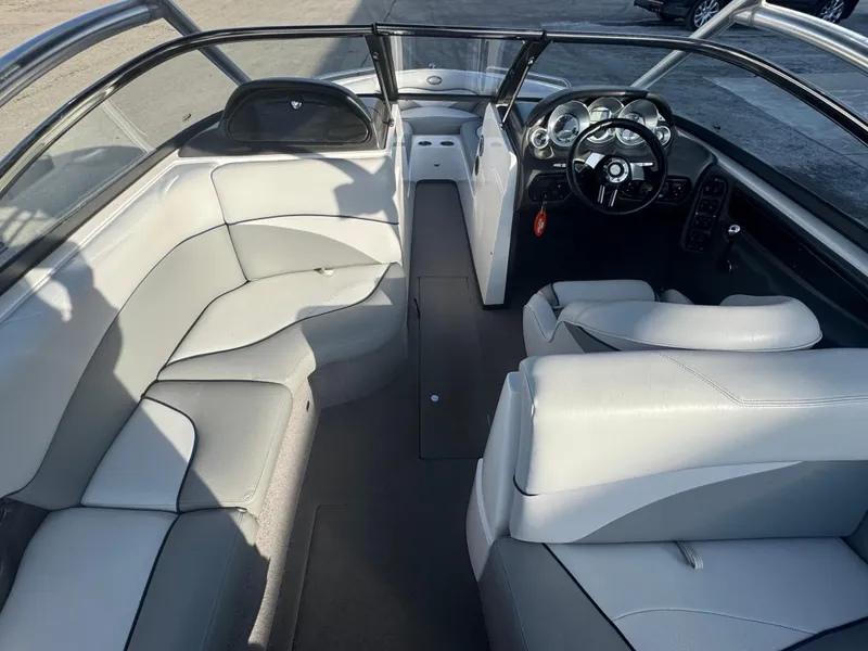 Slide: The Image of 2007 Supra 22SSV boat interior with white seating and sleek dashboard design. - 15