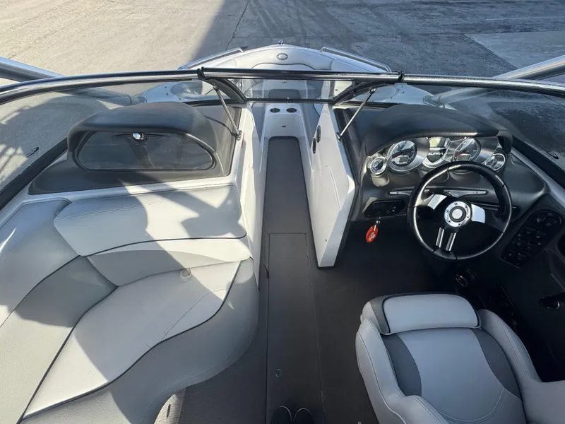 Slide: The Image of 2007 Supra 22SSV boat interior with steering wheel, dashboard, and seating. - 17