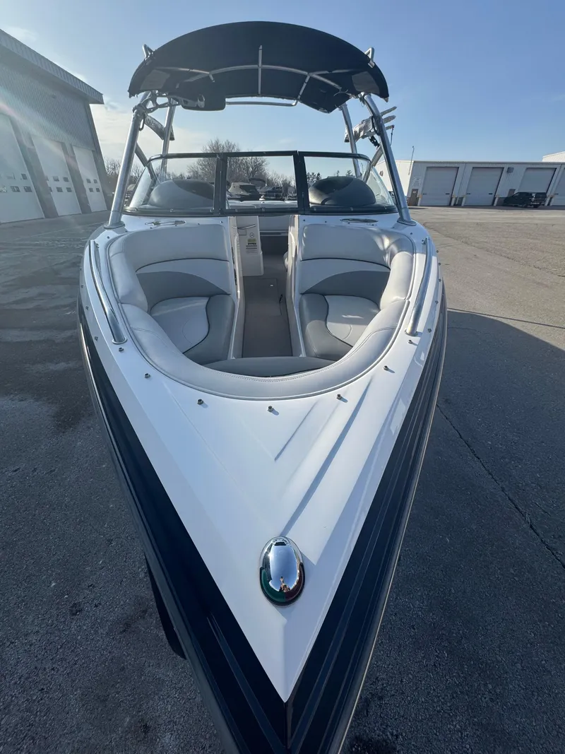 Slide: The Image of 2007 Supra 22SSV boat with sleek design and comfortable seating, parked outdoors. - 4
