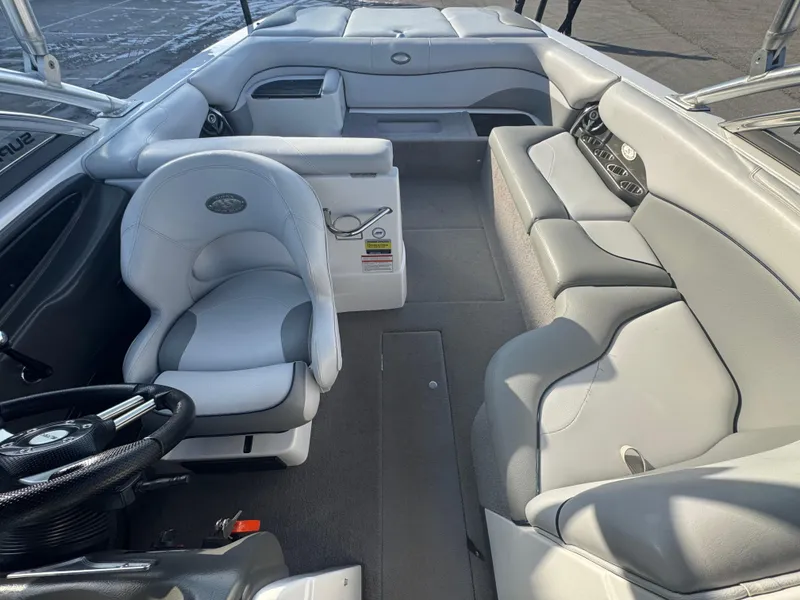 Slide: The Image of 2007 Supra 22SSV boat interior with gray seating and steering wheel. - 6
