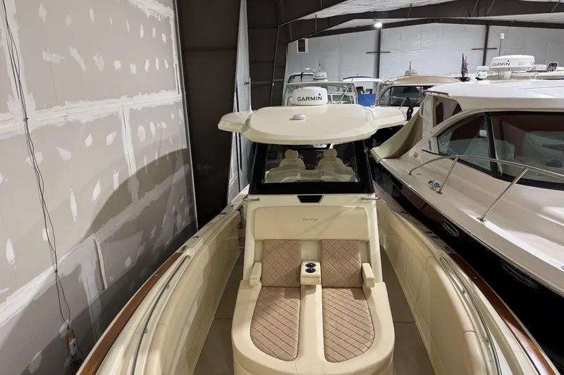 Slide: The Image of 2018 Chris-Craft Catalina 30 CL boat interior with beige seating in a showroom. - 24