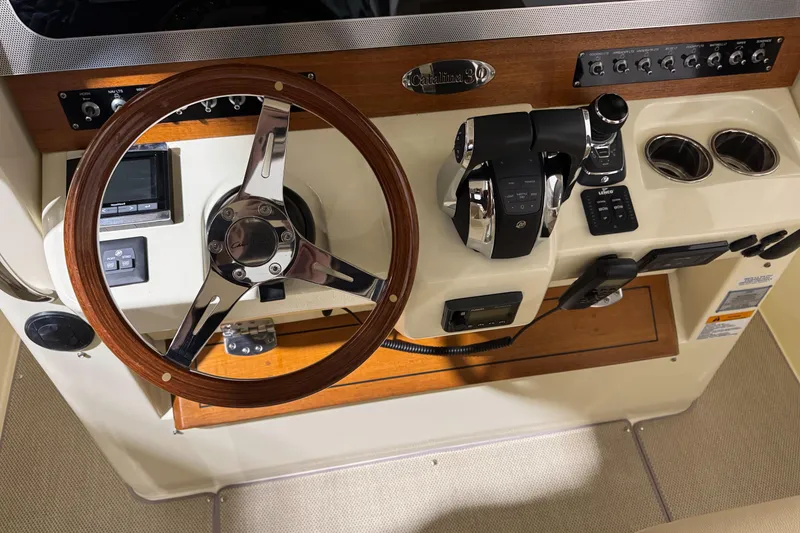 Slide: The Image of 2018 Chris-Craft Catalina 30 CL helm with wooden steering wheel and control panel. - 29