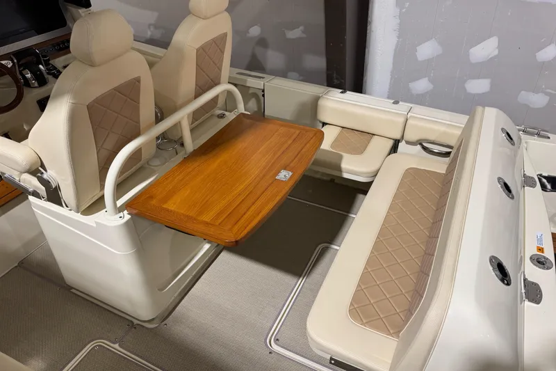 Slide: The Image of 2018 Chris-Craft Catalina 30 CL interior with beige seating and wooden table. - 31