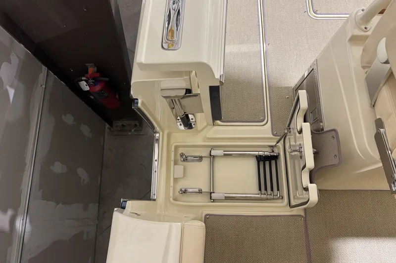 Slide: The Image of 2018 Chris-Craft Catalina 30 CL boat interior with ladder and storage compartment. - 33