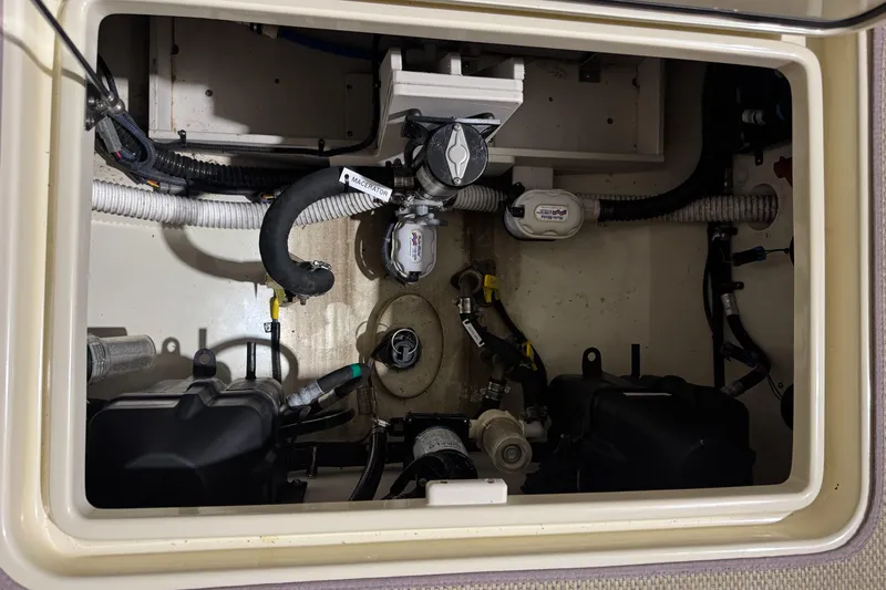 Slide: The Image of Engine compartment of a 2018 Chris-Craft Catalina 30 CL boat, showcasing mechanical components. - 35