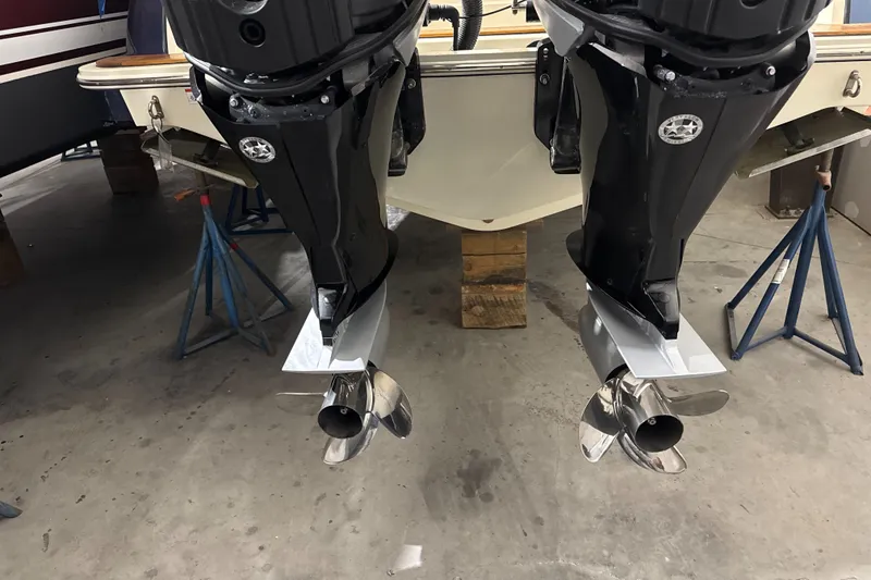 Slide: The Image of 2018 Chris-Craft Catalina 30 CL with dual outboard motors in a garage setting. - 36