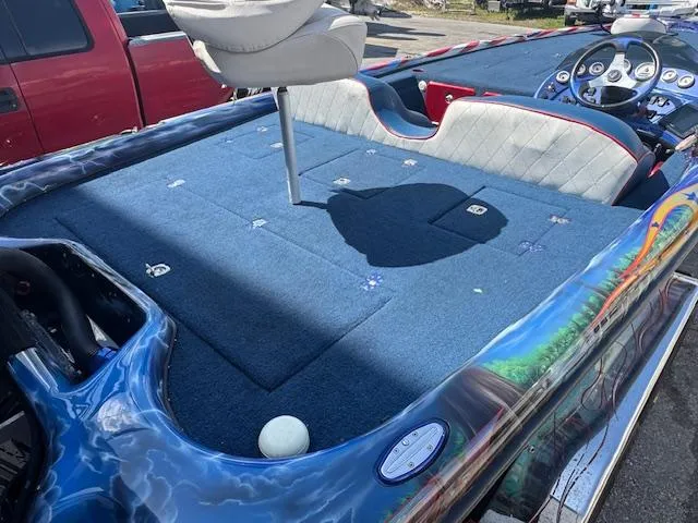 Slide: The Image of 2006 Storm Boats 22 with blue deck, swivel seat, and vibrant exterior design. - 13