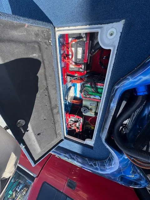 Slide: The Image of Open compartment of a 2006 Storm Boats 22, showing internal components and wiring. - 14