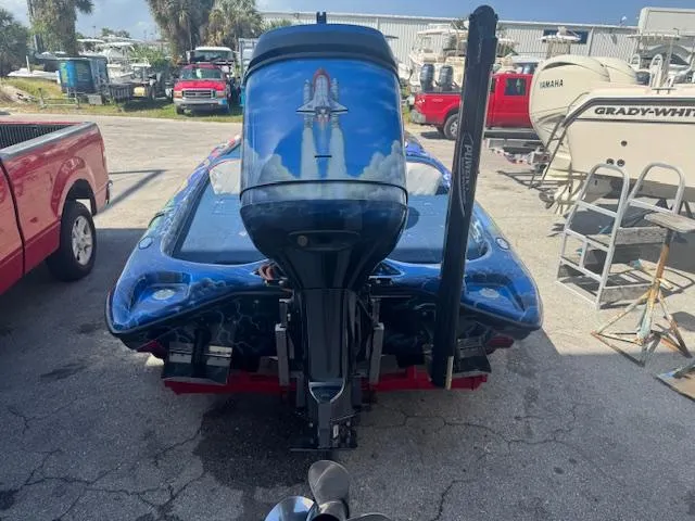 Slide: The Image of 2006 Storm Boats 22 with custom space-themed outboard motor design in a marina setting. - 15