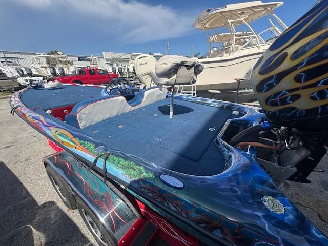 Slide: The Image of 2006 Storm Boats 22 with custom paint, parked in a marina with other boats. - 3