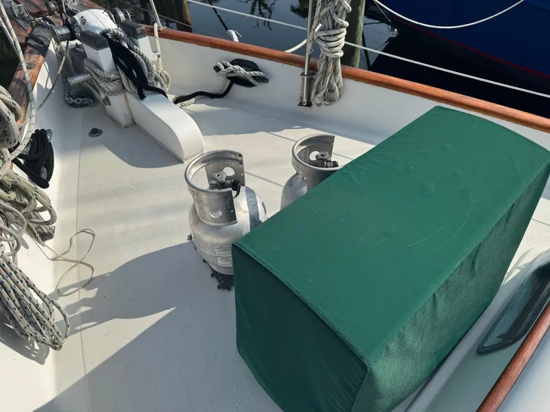 Slide: The Image of Deck of 1989 Hans Christian 43T sailboat with ropes and covered equipment. - 16