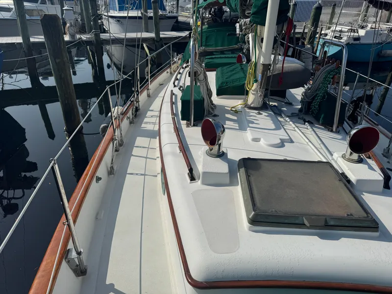 Slide: The Image of 1989 Hans Christian 43T sailboat deck with rigging and marina view. - 21