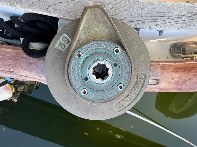 Slide: The Image of Winch on 1989 Hans Christian 43T sailboat, docked with visible water reflection. - 27