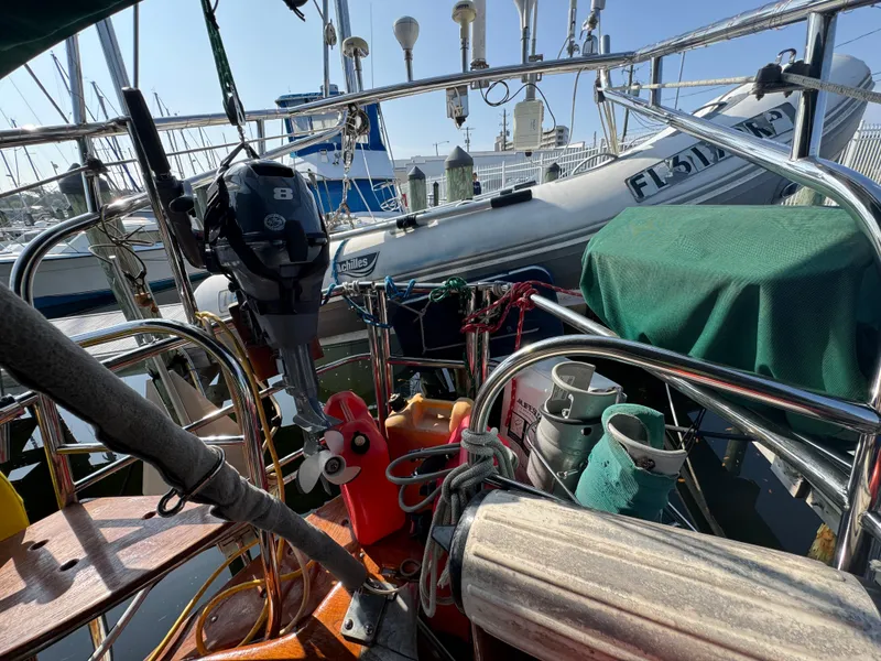 Slide: The Image of Cockpit of 1989 Hans Christian 43T sailboat with equipment and dinghy in marina. - 29