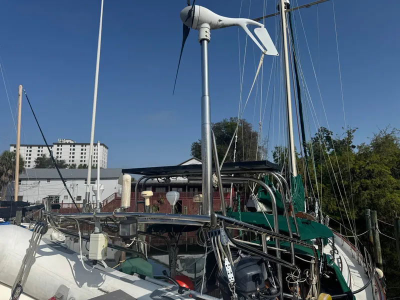 Slide: The Image of Sailboat Hans Christian 43T, 1989 model, docked with visible wind turbine and rigging. - 3