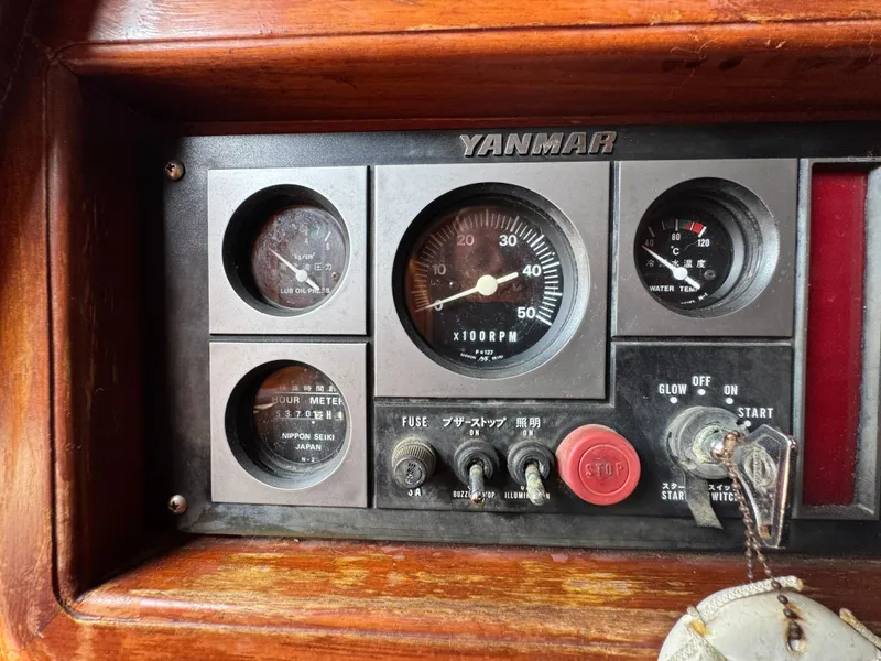 Slide: The Image of Yanmar engine control panel on 1989 Hans Christian 43T sailboat, featuring gauges and switches. - 34