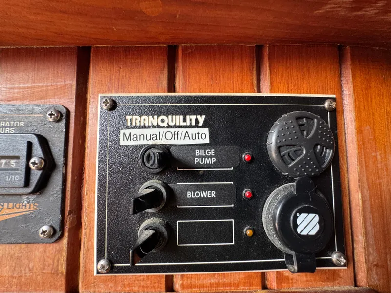 Slide: The Image of Control panel on a 1989 Hans Christian 43T boat, featuring bilge pump and blower switches. - 36