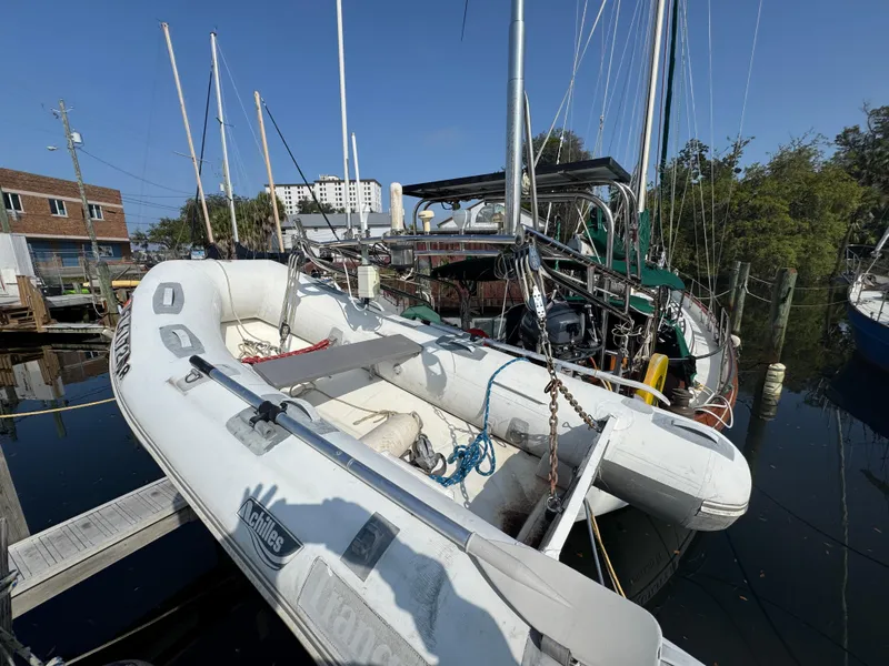 Slide: The Image of Sailboat Hans Christian 43T (1989) docked with inflatable dinghy in marina. - 4