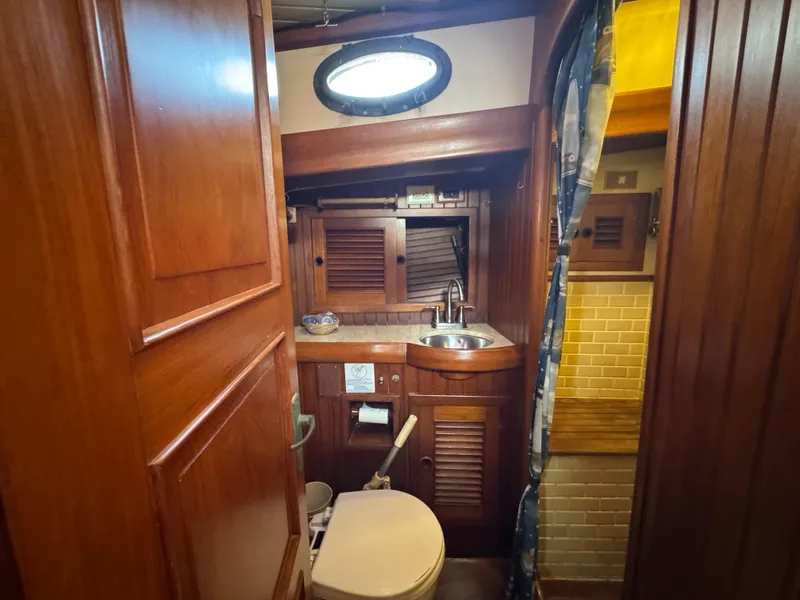 Slide: The Image of 1989 Hans Christian 43T yacht bathroom with wooden interior and compact design. - 48