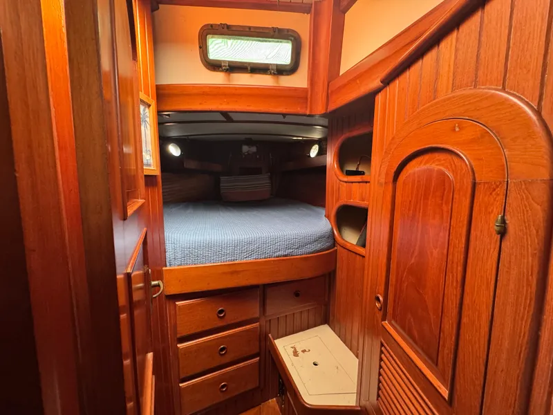 Slide: The Image of Cozy wooden cabin interior of 1989 Hans Christian 43T sailboat with bed and storage. - 49