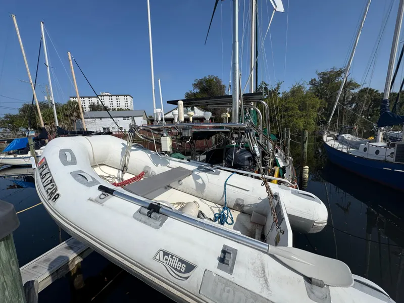 Slide: The Image of Sailboat docked with inflatable dinghy, Hans Christian 43T, 1989 model, in a marina setting. - 5