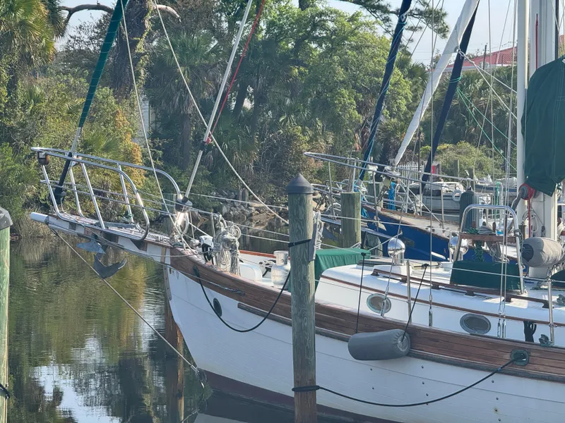 Slide: The Image of Sailboat Hans Christian 43T, 1989 model, docked in a serene marina setting. - 7