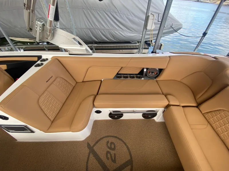 Slide: The Image of 2020 MasterCraft X26 boat interior with tan leather seating and lake view. - 16
