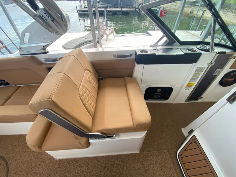 Slide: The Image of 2020 MasterCraft X26 boat interior with tan seating and open deck view. - 24