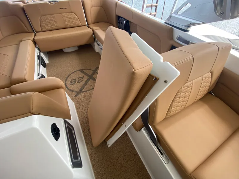 Slide: The Image of 2020 MasterCraft X26 boat interior with tan leather seating and foldable backrest. - 29