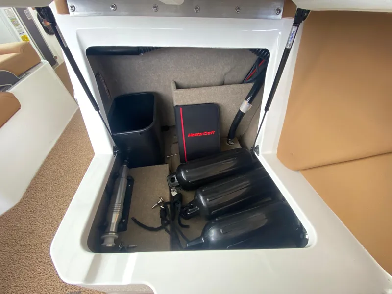 Slide: The Image of Storage compartment in a 2020 MasterCraft X26 boat with equipment and accessories. - 31