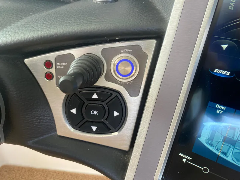 Slide: The Image of Control panel of a 2020 MasterCraft X26 boat with joystick and digital display. - 36