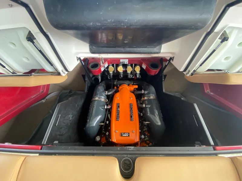 Slide: The Image of 2020 MasterCraft X26 engine compartment with vibrant orange engine cover. - 44