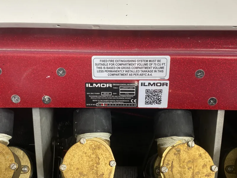 Slide: The Image of 2020 MasterCraft X26 engine compartment with Ilmor label and fire safety instructions. - 46