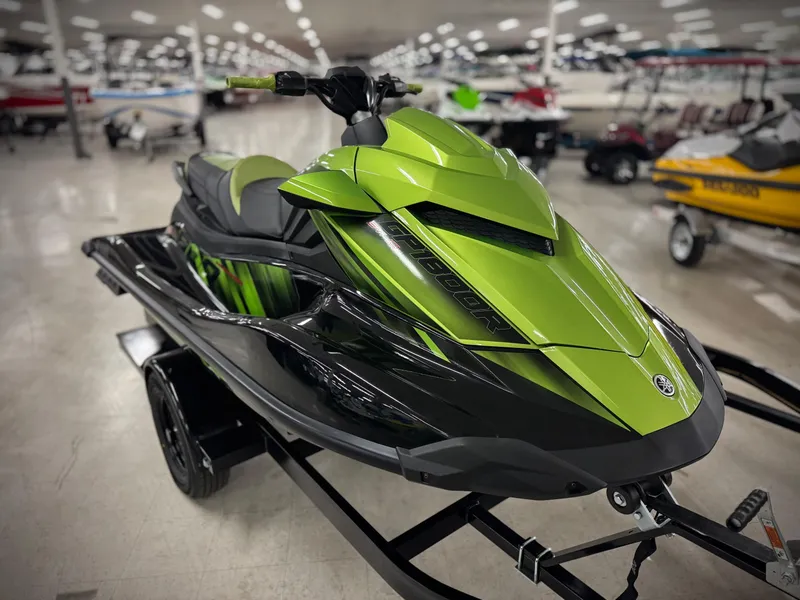 Slide: The Image of 2023 Yamaha WaveRunner GP1800R in vibrant green, displayed indoors on a trailer. - 2