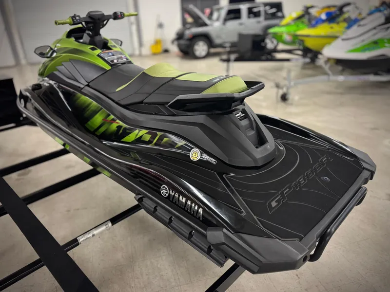 Slide: The Image of 2023 Yamaha WaveRunner GP1800R in showroom, featuring sleek black and green design. - 4