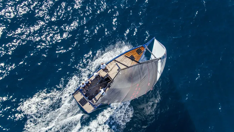 Slide: The Image of Aerial view of Black Pepper Code 0.1 sailboat navigating blue ocean waters, 2025 model. - 14