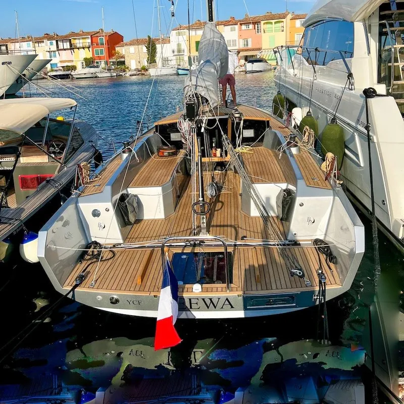 Slide: The Image of Modern Black Pepper Code 0.1 yacht docked, featuring sleek design and French flag. - 16