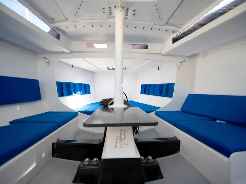 Slide: The Image of Interior of Black Pepper Code 0.1 sailboat, featuring blue seating and modern design, 2025 model. - 26